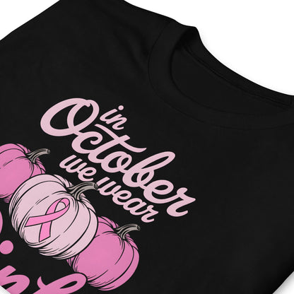Black breast cancer awareness t-shirt with pink ribbon and pumpkins with pink pumpkins and 'in October we wear' text on a white background