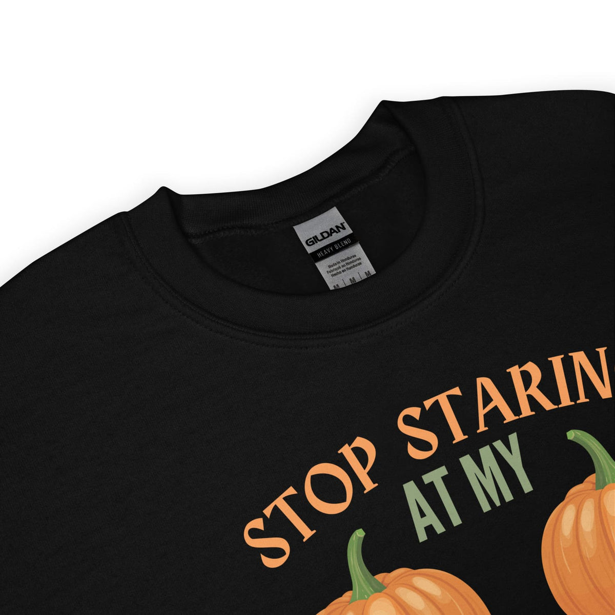 Black adult humor halloween sweatshirt with text 'STOP STARING AT MY pumpkins' on a white background