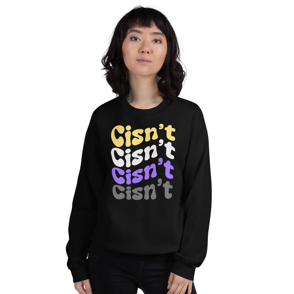Person wearing a black nonbinary sweatshirt with 'Cisn't' text in multiple colors on a white background