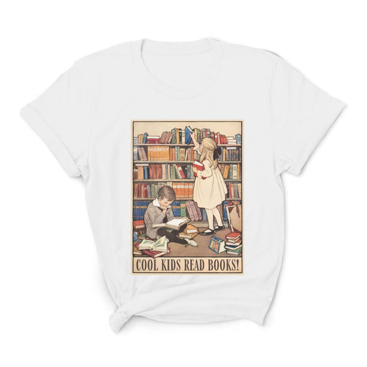 White t-shirt with a graphic of children reading books and 'Cool Kids Read Books!' text on a white background.