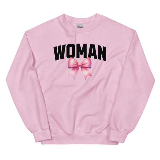 Pink mtf transgender sweatshirt with 'WOMAN' and a bow graphic on a white background