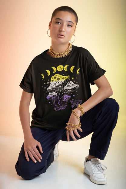 nonbinary shirt, cottagecore design with frog, mushrooms and moon phases, in use