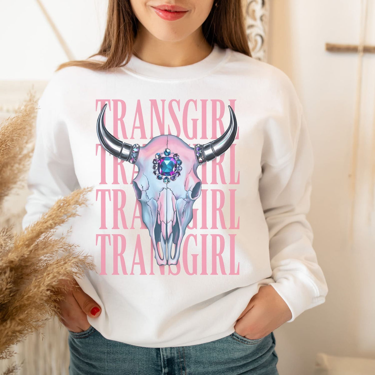 MTF transgender Person wearing a white sweatshirt with a skull design and 'TRANSGIRL' text.