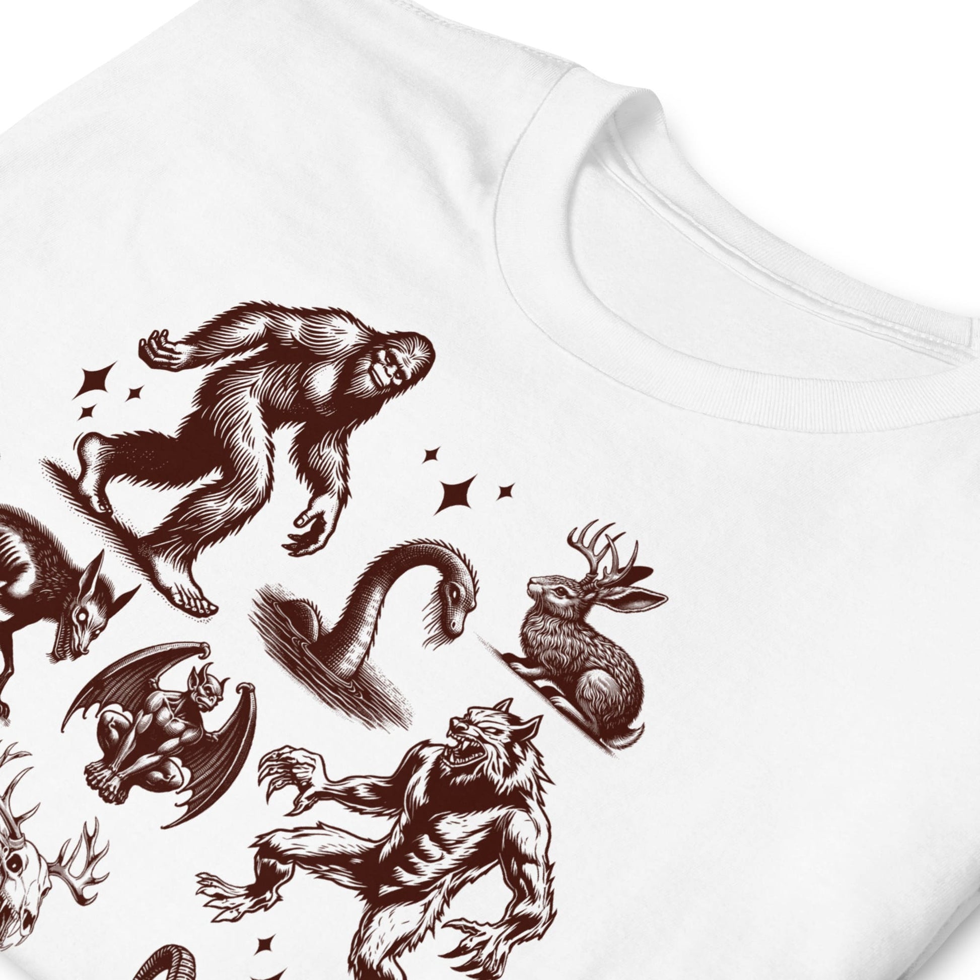 White t-shirt with brown fantasy creature illustrations on a white background