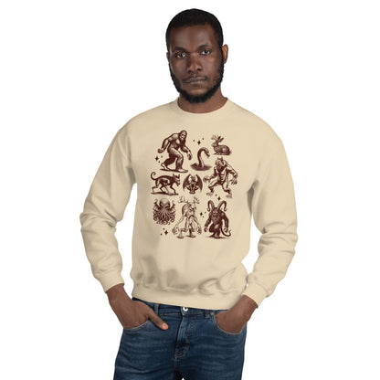 Man wearing a beige sweatshirt with cryptids  on a white background