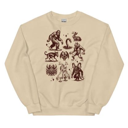 Beige sweatshirt with cryptids designs on a white background