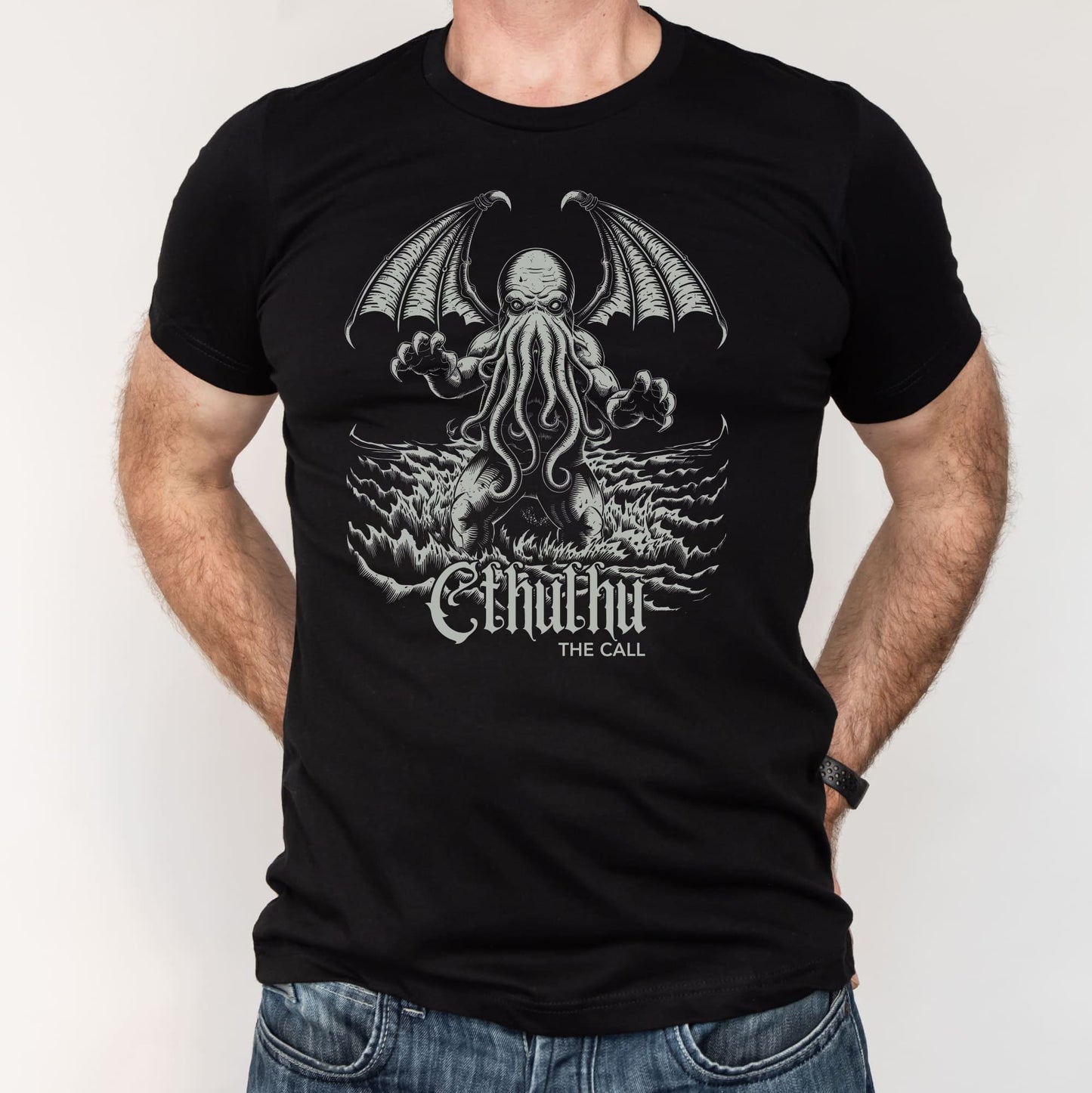 Black t-shirt with a graphic design of cthulhu, worn by a person.