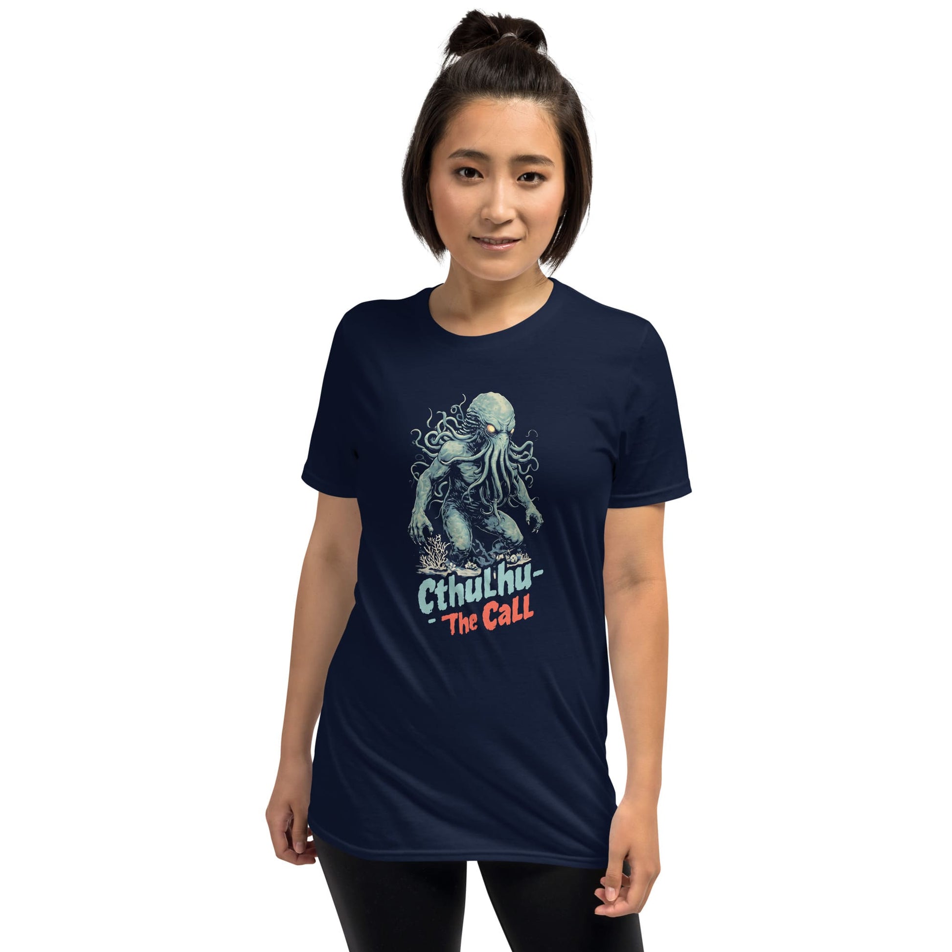 Person wearing a navy blue t-shirt with cthulhu on a white background