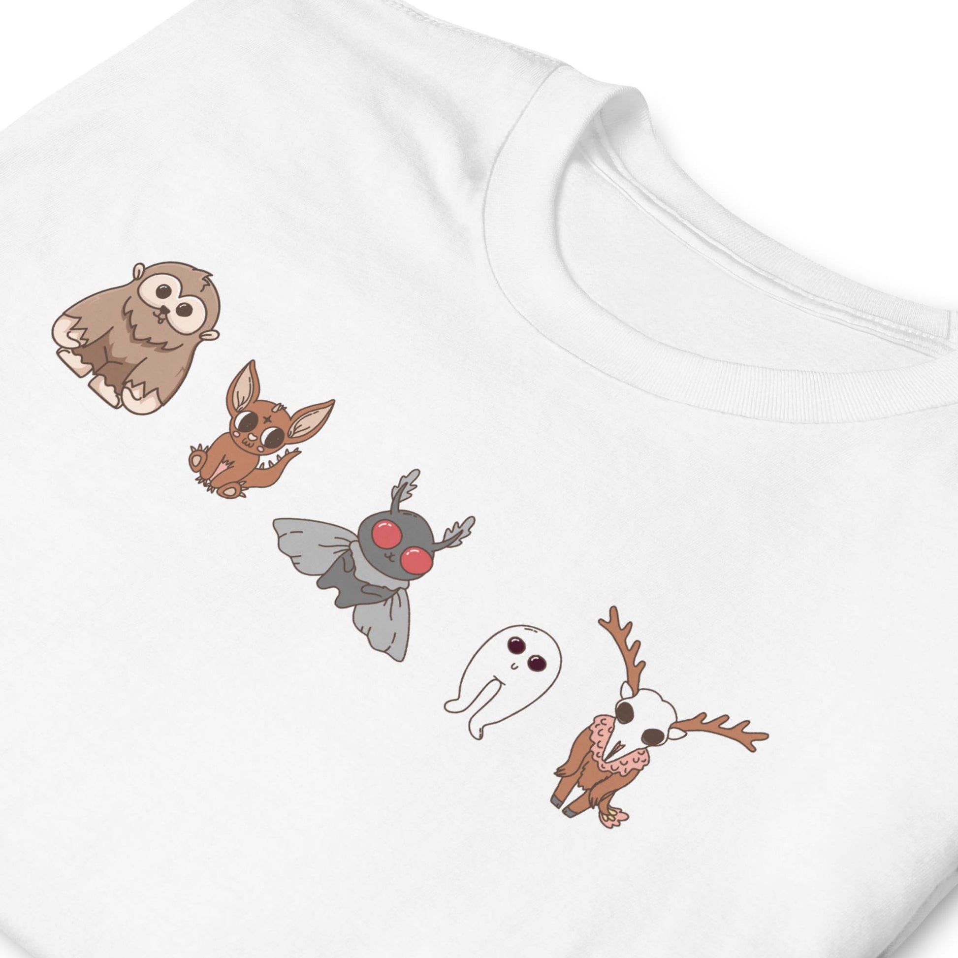White t-shirt with cartoon animal designs on a white background: Cute Cryptids Comfort Colors Shirt, Kawaii Bigfoot Chupacabra Mothman Fresno Wendigo Tee, Funny Cryptidcore Gift, Folklore Mythology T-Shirt