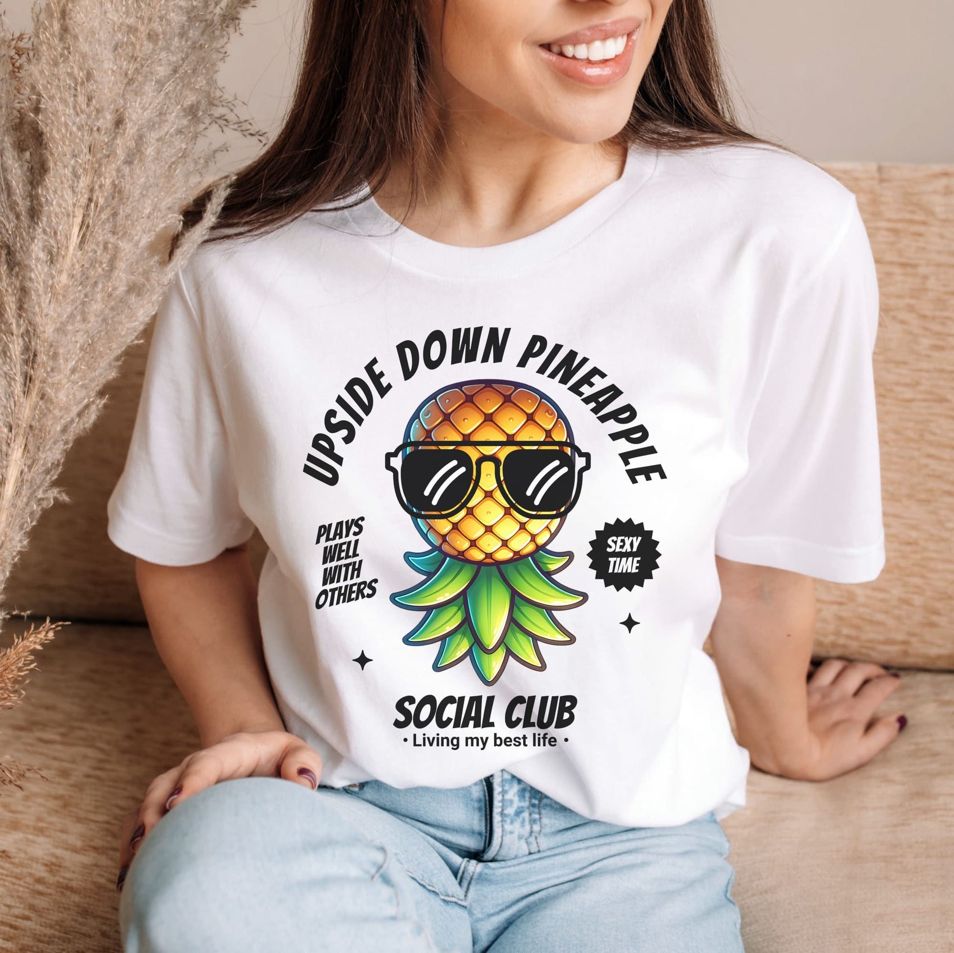 Person wearing a white t-shirt with a pineapple graphic and text: Funny Swingers Shirt, Cute Upside Down Pineapple Social Club Tee, Gift For Non Monogamy Swinging Lifestyle Couples, Cool Summer Adult Humor