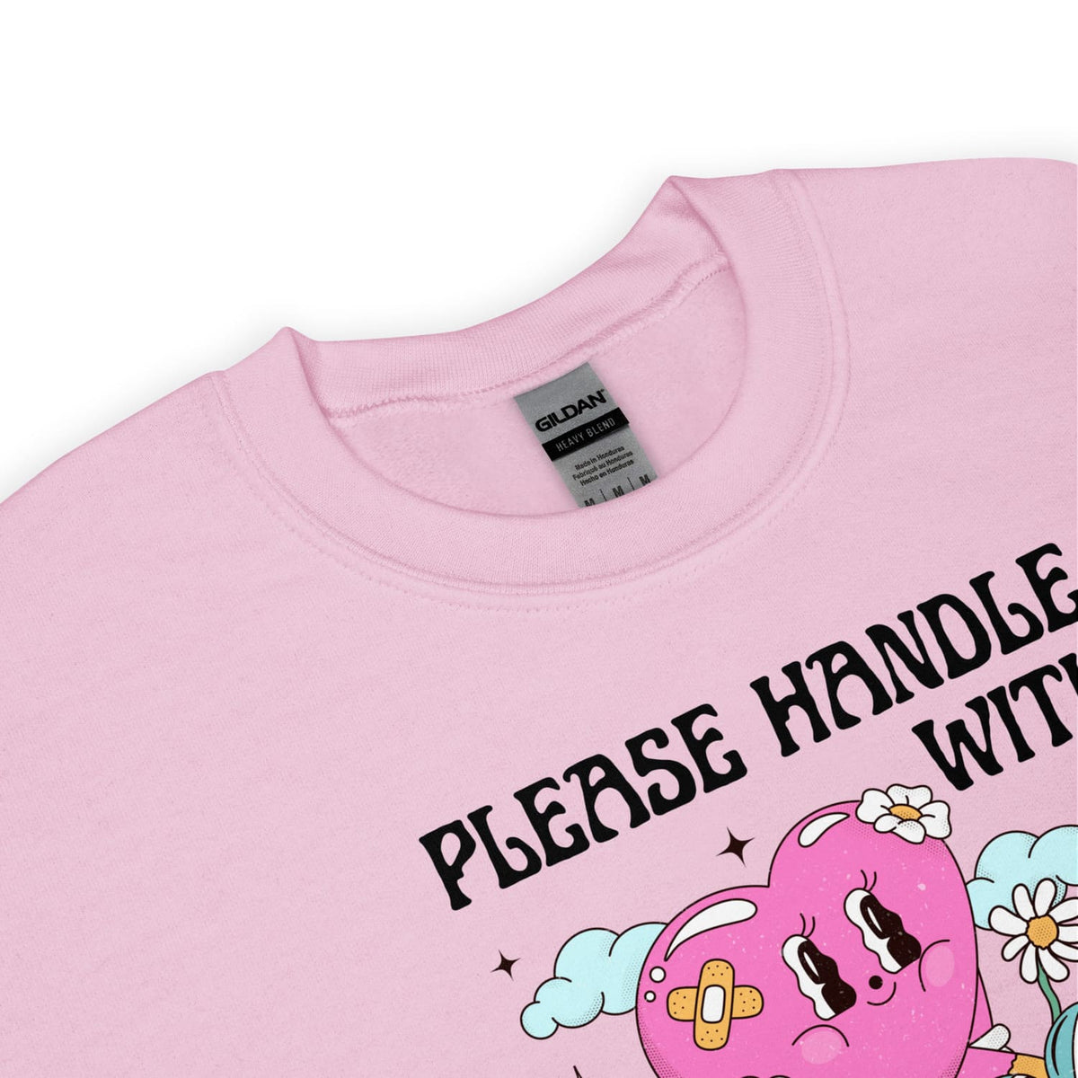 Pink autism sweatshirt with cartoon design and text 'PLEASE HANDLE WITH CARE' on a white background