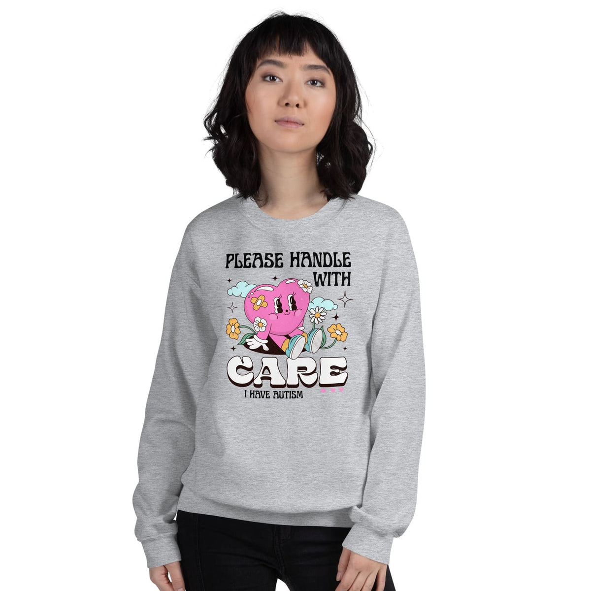Person wearing a gray autism sweatshirt with a cartoon character and text on a white background