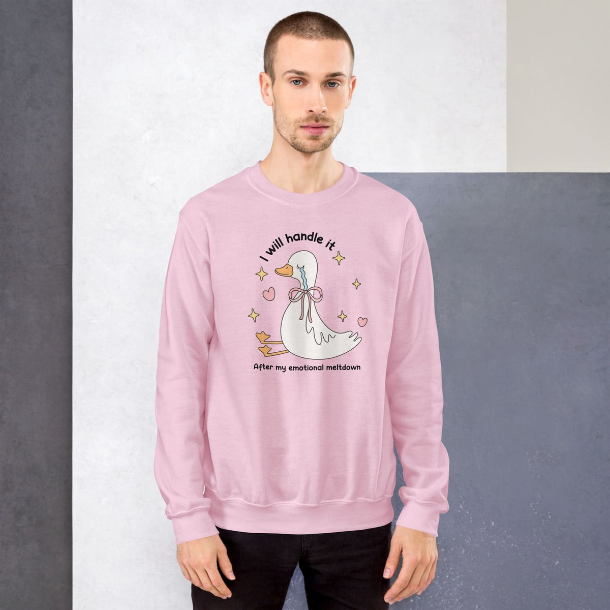 Person wearing a pink mental health sweatshirt with a goose graphic and text against a plain background