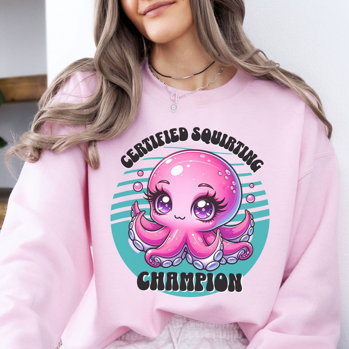 Person wearing a pink adult humor sweatshirt with a cartoon octopus design and text.