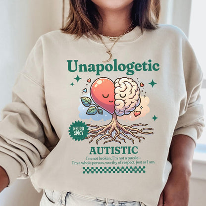 Person wearing a beige sweatshirt with a colorful graphic and text about autism.