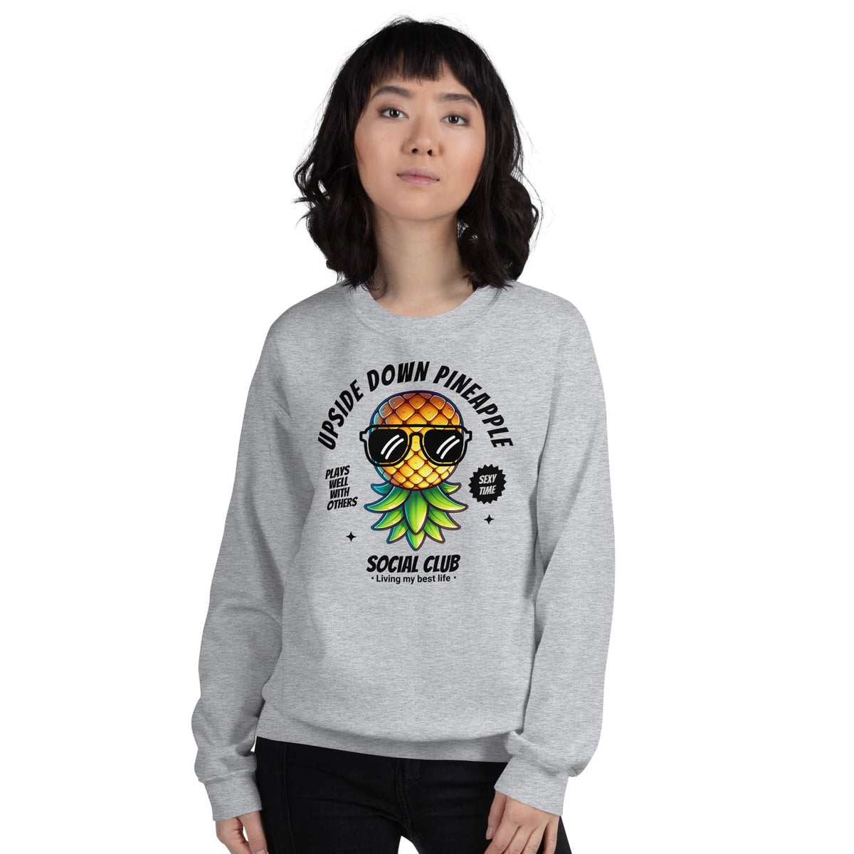 Person wearing a gray swingers sweatshirt with an 'Upside Down Pineapple Social Club' design.