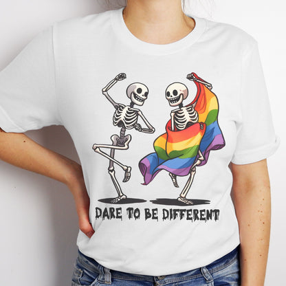 White t-shirt with skeletons dancing, one wrapped in a rainbow flag, and 'Dare to be Different' text: Dancing Skeletons Pride Shirt, Dare To Be Different LGBTQ Halloween Tee, Rainbow Flag Seasonal T-Shirt, Gay Queer Spooky Gift