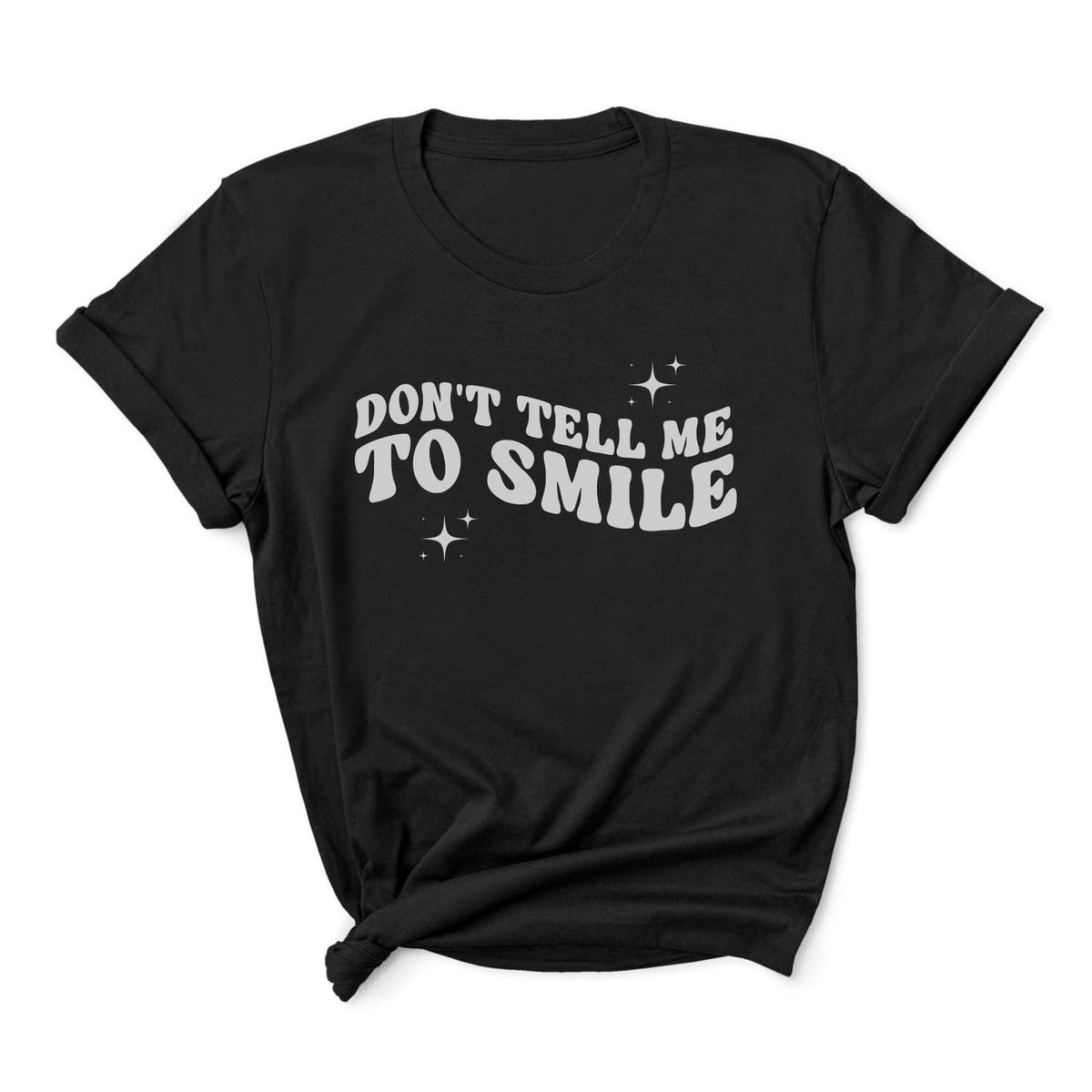 Black feminist t-shirt with 'Don't Tell Me To Smile' text on a white background