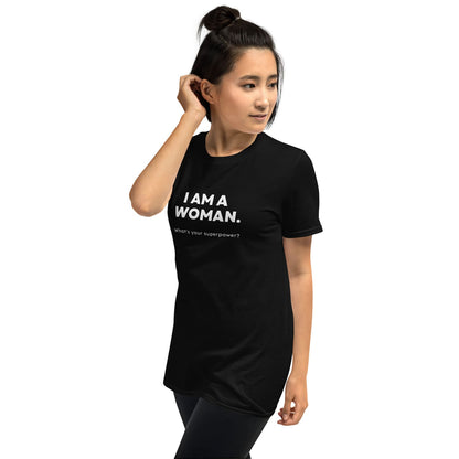 Woman wearing a black feminist t-shirt with 'I AM A WOMAN. What's your superpower?' text on a white background