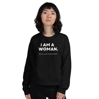 Person wearing a black feminist sweatshirt with 'I AM A WOMAN. What's your superpower?' text on a white background