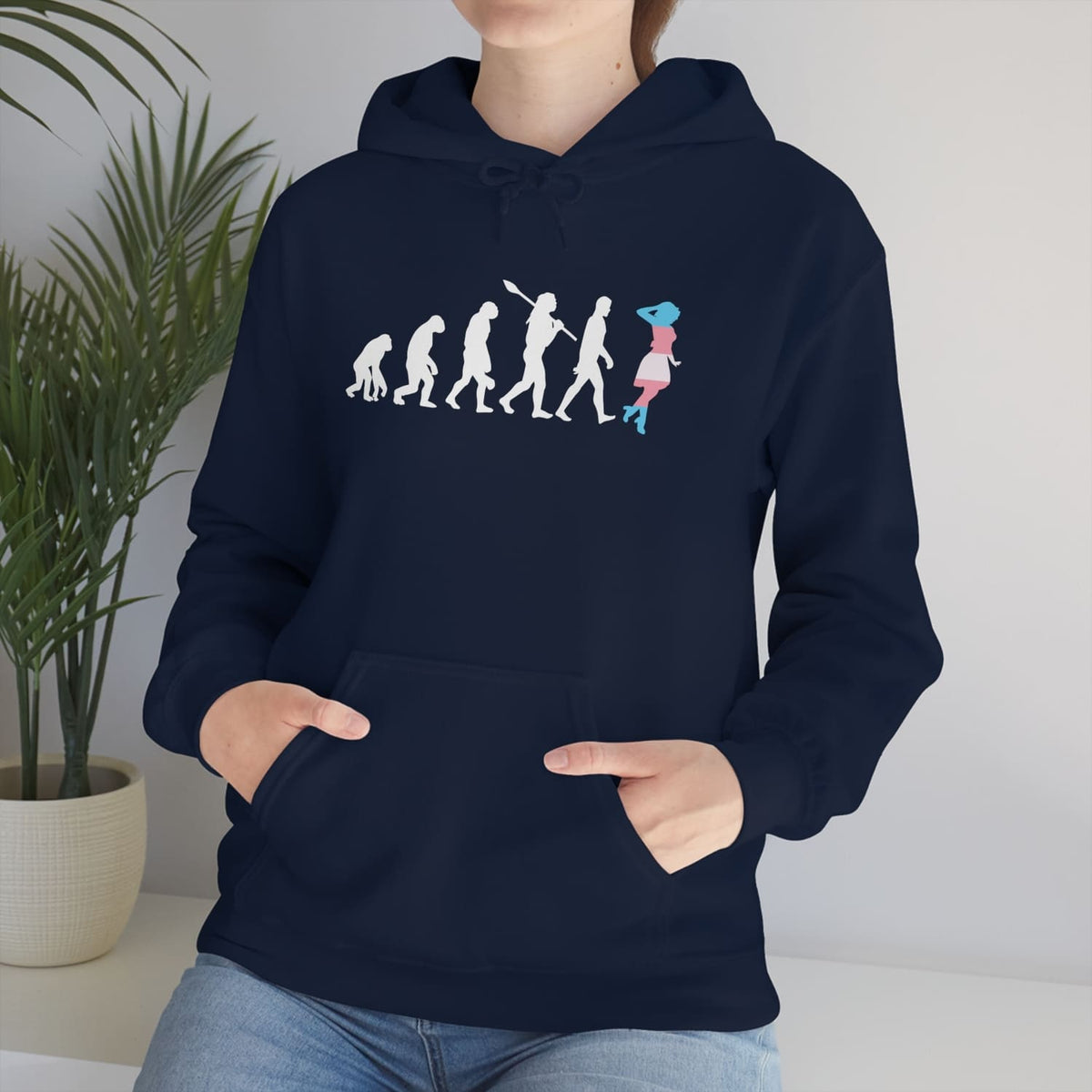 Person wearing a navy blue transgender mtf hoodie with a unique design, standing indoors next to a plant.