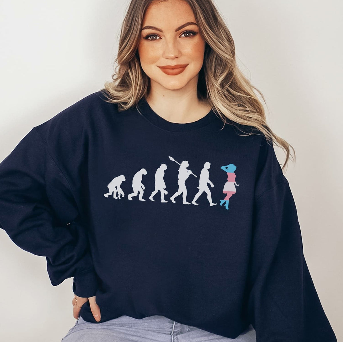 MTF transgender wearing a navy blue sweatshirt with a graphic design on a plain background