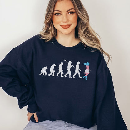 MTF transgender wearing a navy blue sweatshirt with a graphic design on a plain background