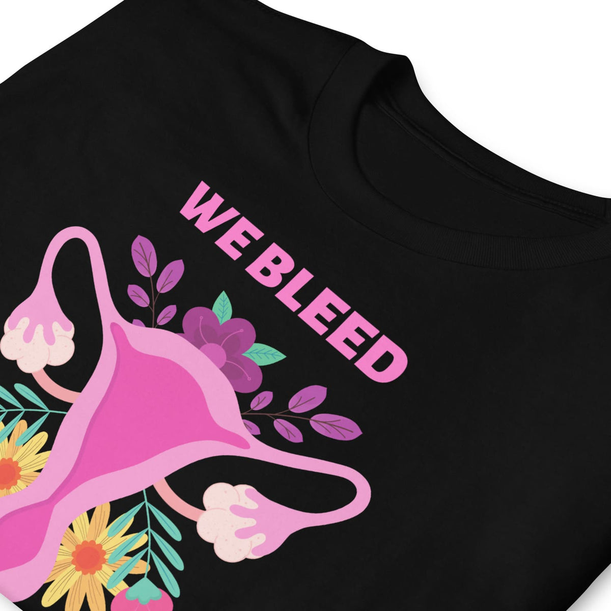 Black feminist t-shirt with pink uterine diagram and flowers, featuring the text 'WE BLEED'.