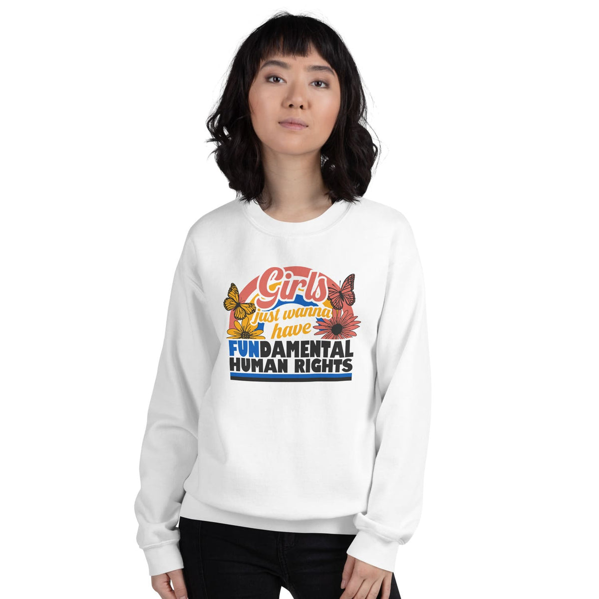 Person wearing a white feminist sweatshirt with a colorful graphic and text on a white background