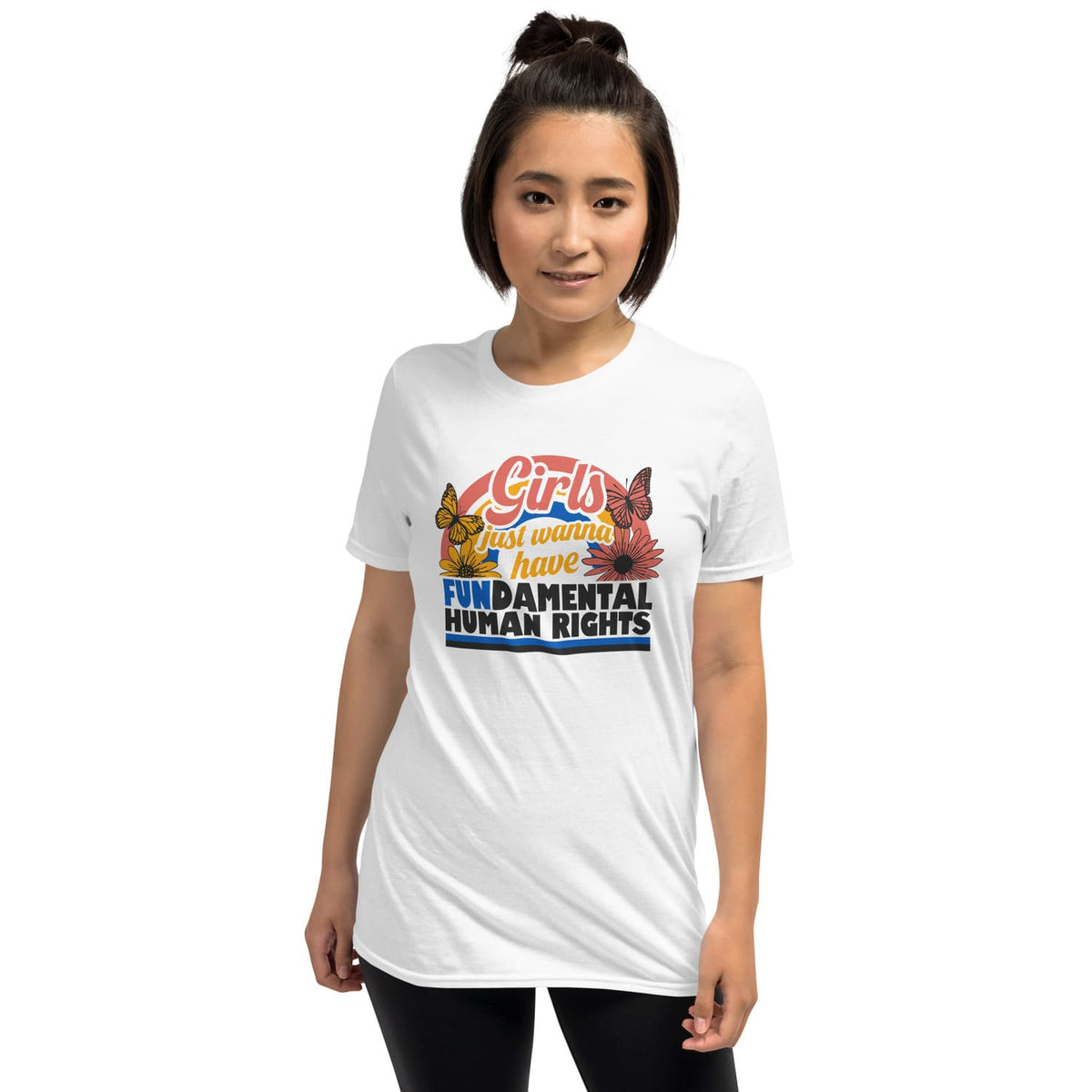 Woman wearing a white feminist t-shirt with a colorful graphic and text on a white background