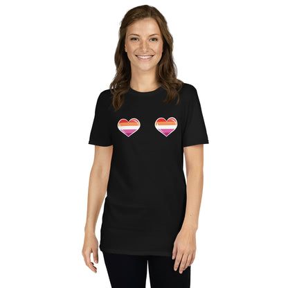 Woman wearing a cheesy lesbian black t-shirt with heart designs on a white background