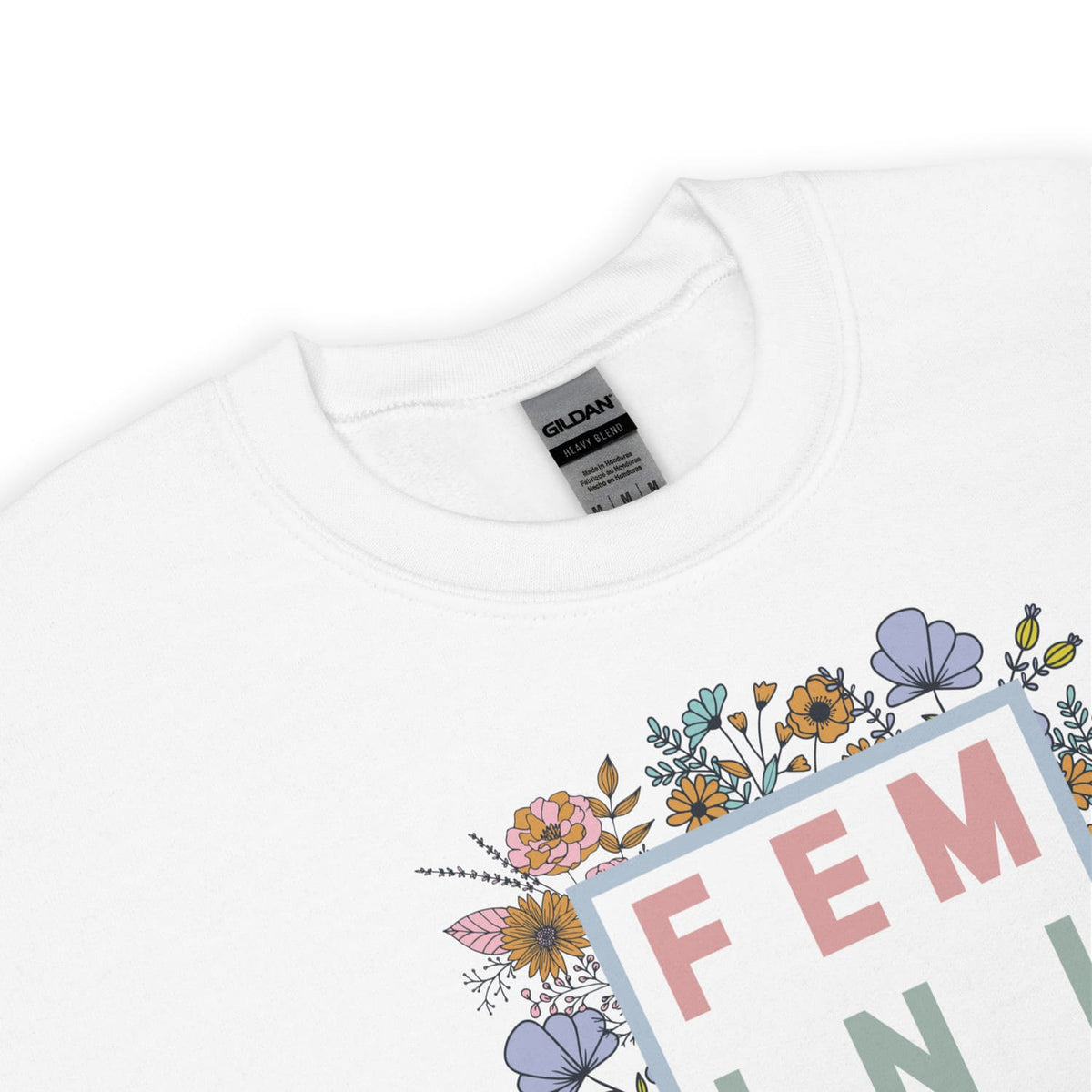 White sweatshirt with floral design and 'FEMINIST' text on a white background