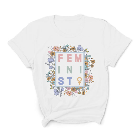 White t-shirt with 'FEMINIST' text and floral design on a white background