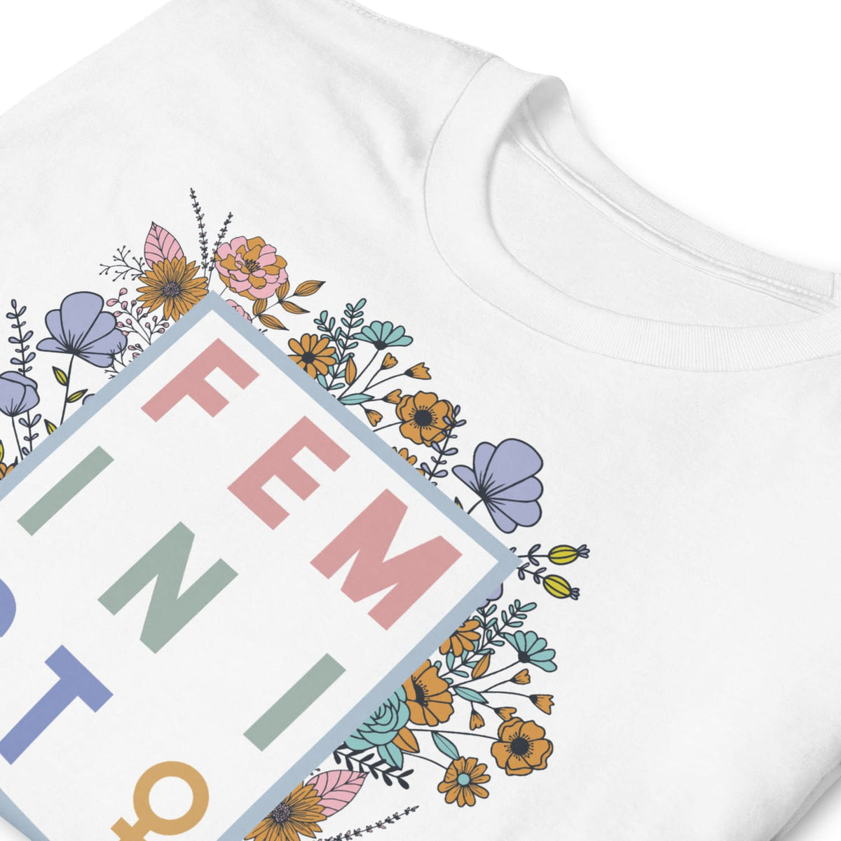 White feminist shirt with floral designs and text on a white background