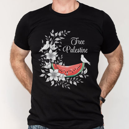 Black t-shirt with 'Free Palestine' design featuring a watermelon slice, birds, and flowers on a white background.