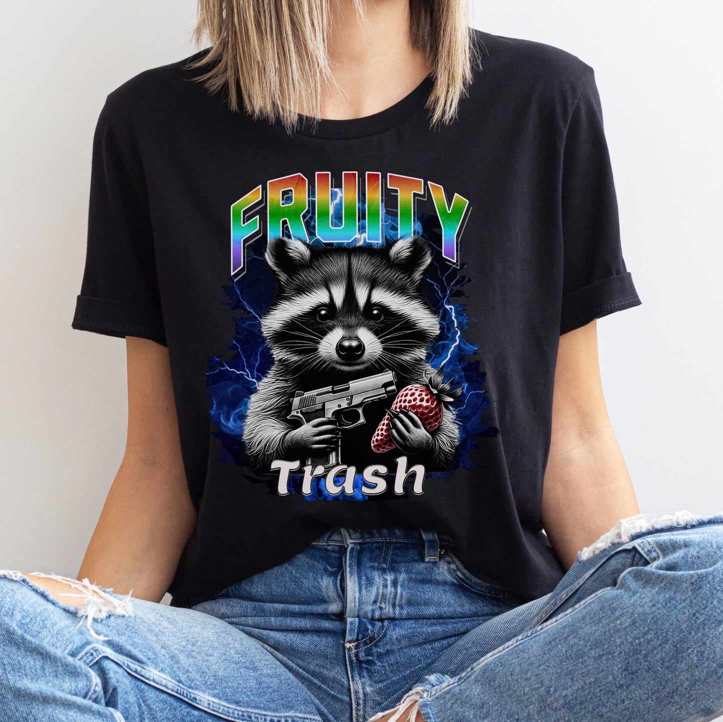 Person wearing a queer black y2k bootleg t-shirt with a raccoon graphic and 'Fruity Trash' text.