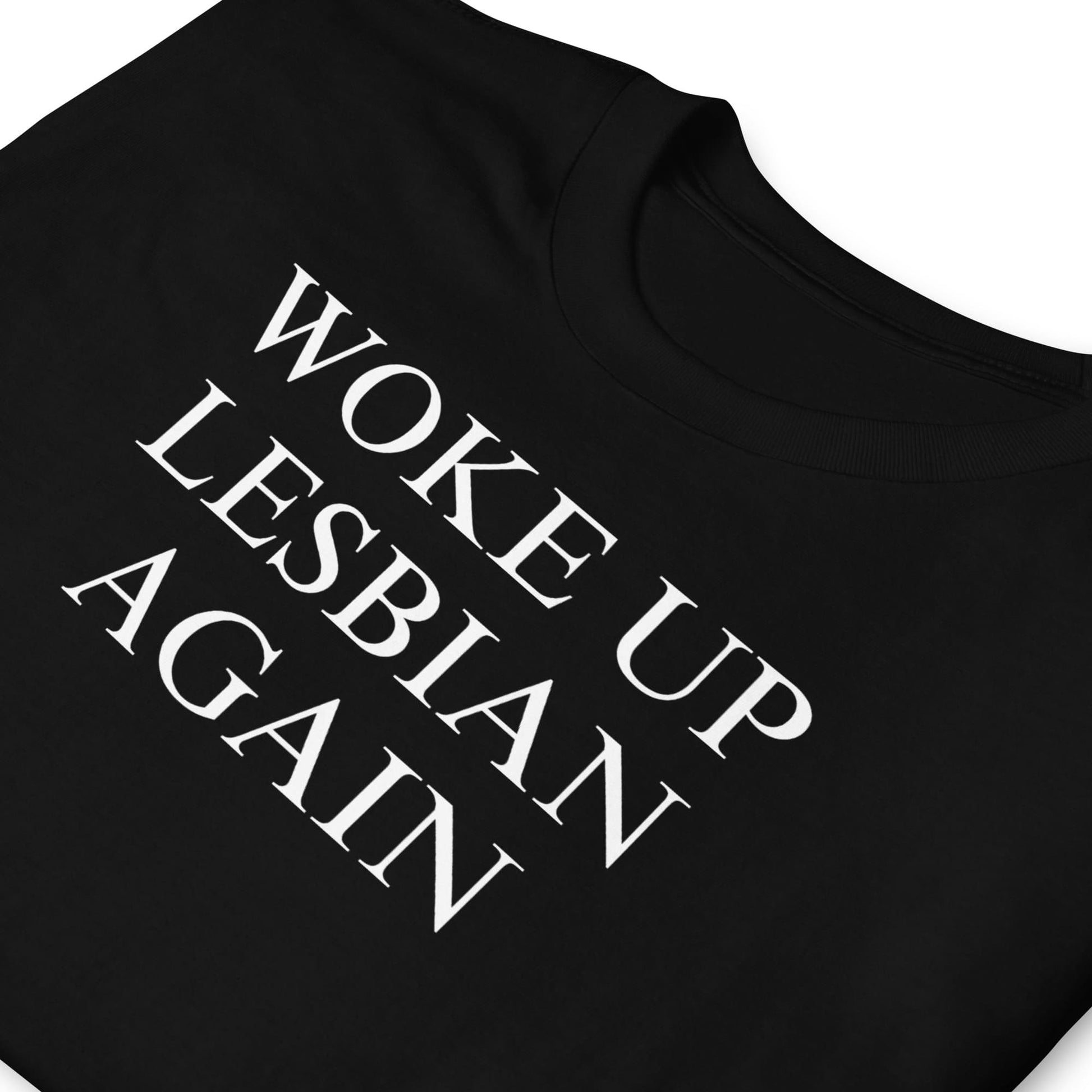 Black t-shirt with white text 'WOKE UP LESBIAN AGAIN' on a white background