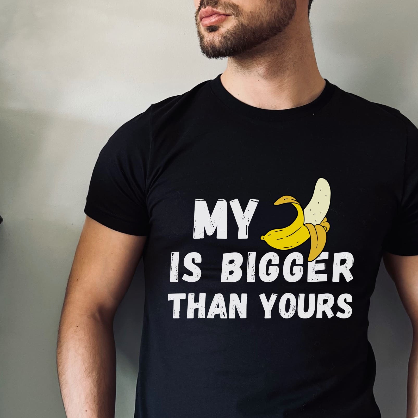 Person wearing a black t-shirt with a banana graphic and text.