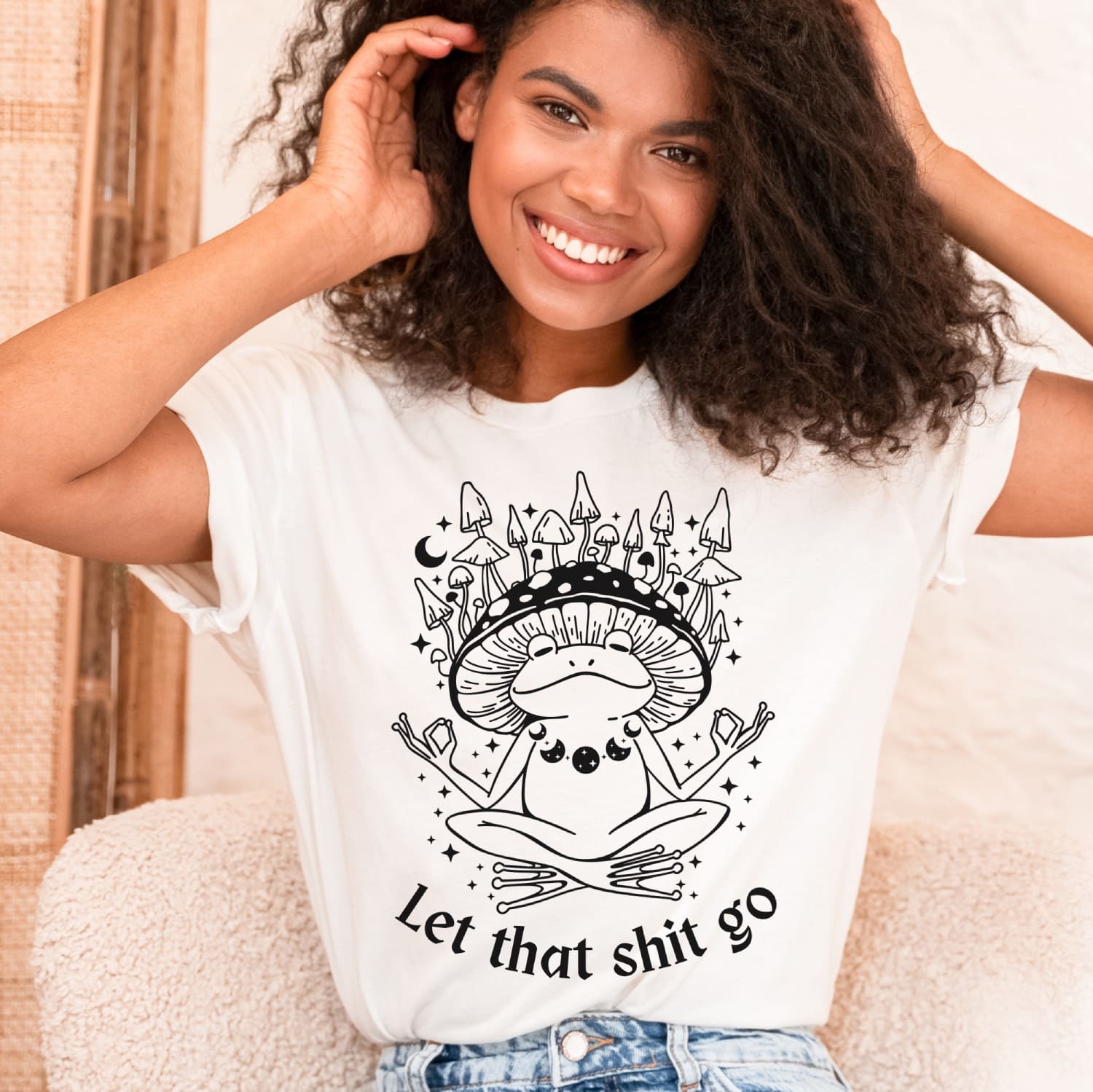 Woman wearing a white t-shirt with a black graphic design and text.