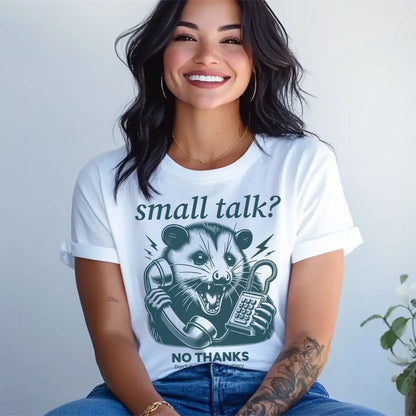 Person wearing a white t-shirt with a graphic design of an opossum on a phone and text 'small talk? NO THANKS' against a plain background: Funny Social Anxiety Shirt, Introvert Socially Awkward Tee, Unhinged Opossum Tee, Neurodivergent T-Shirt For Neurospicy, Gift For Therapist