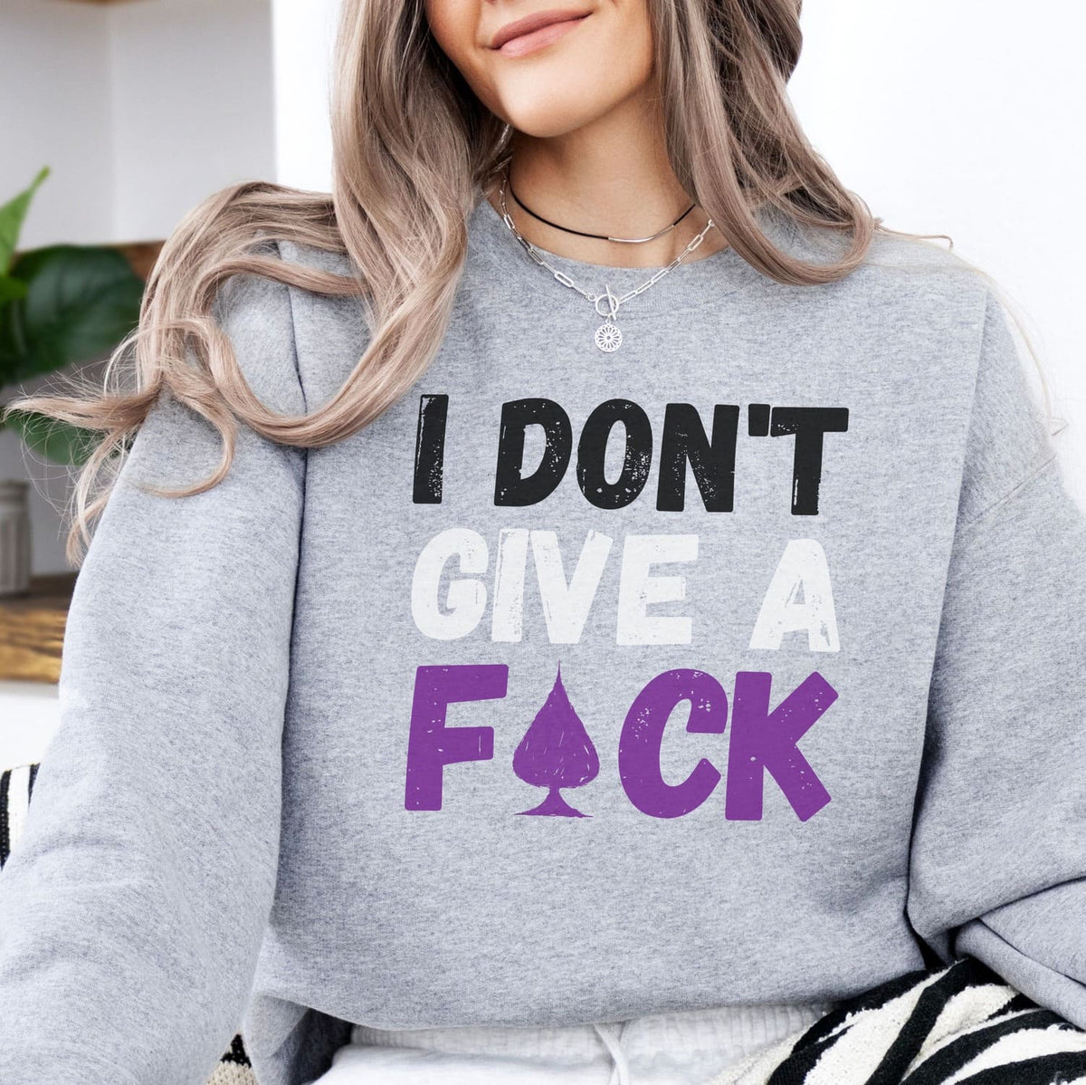 Person wearing a gray asexual sweatshirt with a bold text design.
