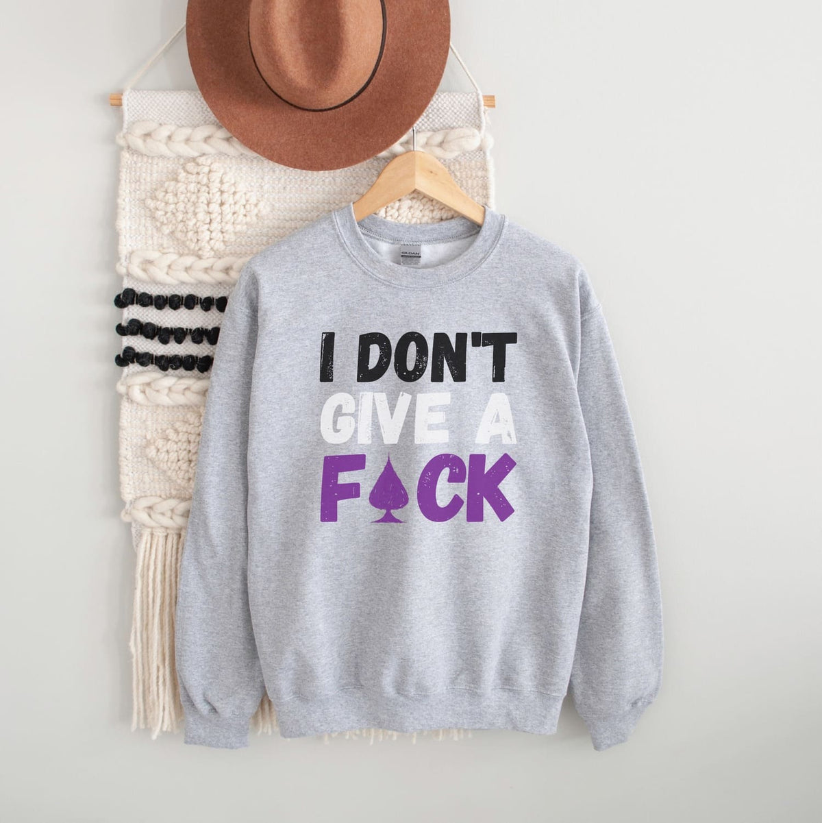 Gray asexual sweatshirt with text 'I DON'T GIVE A F*CK' on a white background