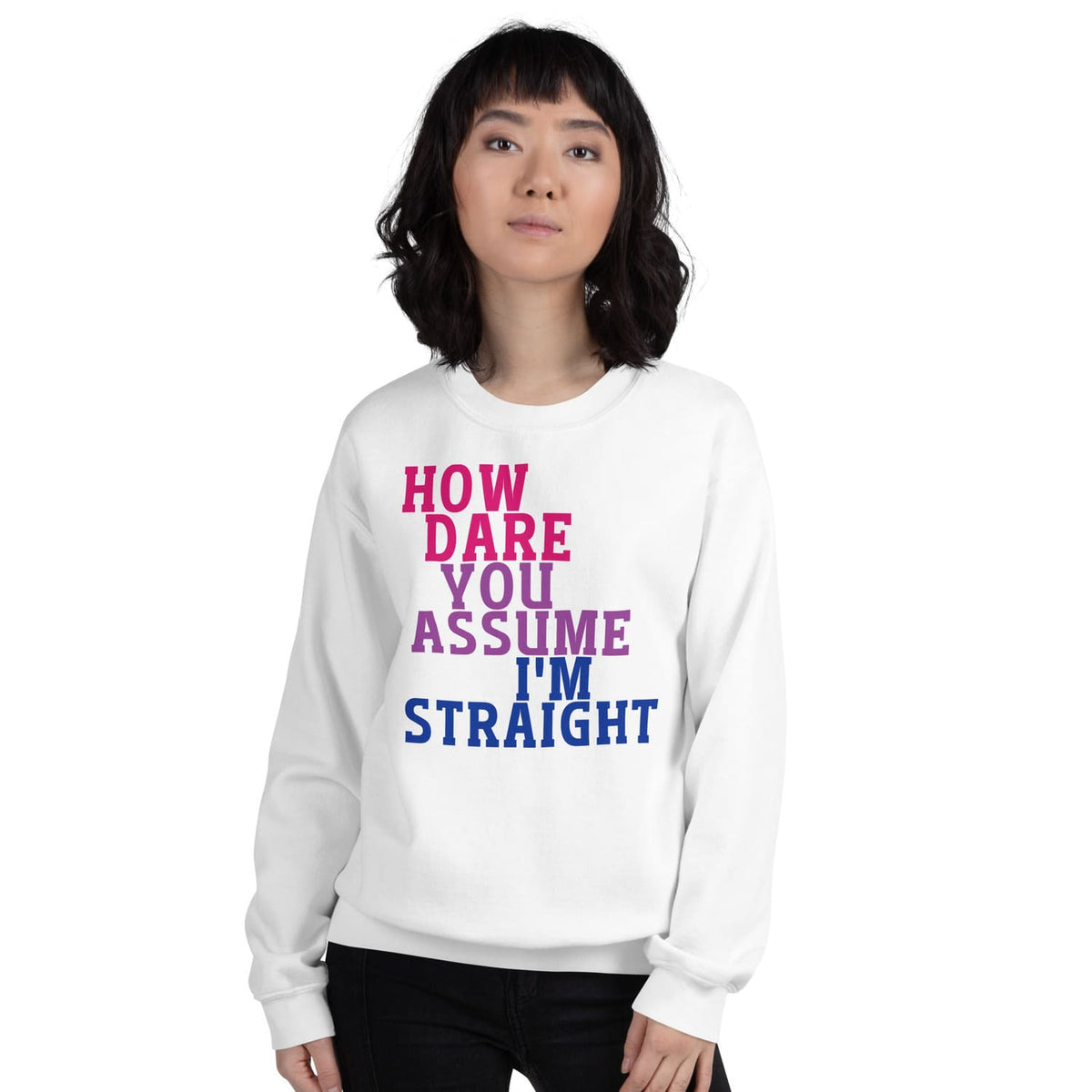 Person wearing a white bisexual sweatshirt with colorful text on a white background