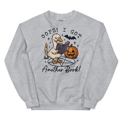 Gray sweatshirt with a graphic of a duck reading a book, surrounded by Halloween elements like a pumpkin and candle, on a white background.