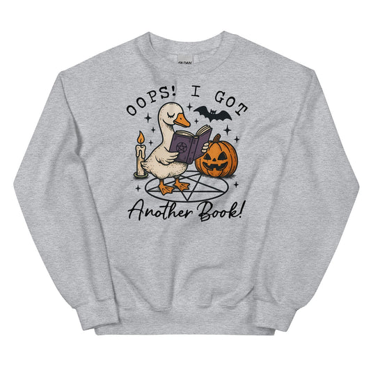 Gray sweatshirt with a graphic of a duck reading a book, surrounded by Halloween elements like a pumpkin and candle, on a white background.