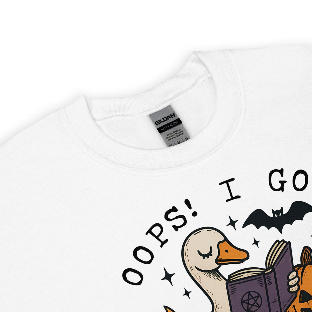 White sweatshirt with a cartoon duck reading a book and text 'Oops! I Got', brand label visible.