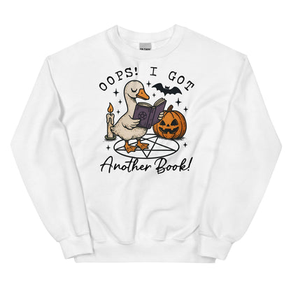 White sweatshirt with a graphic of a duck reading a book, surrounded by Halloween elements like a pumpkin and candle, on a white background.