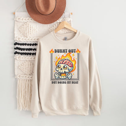 Beige burnout sweatshirt with skull design and text on a white background