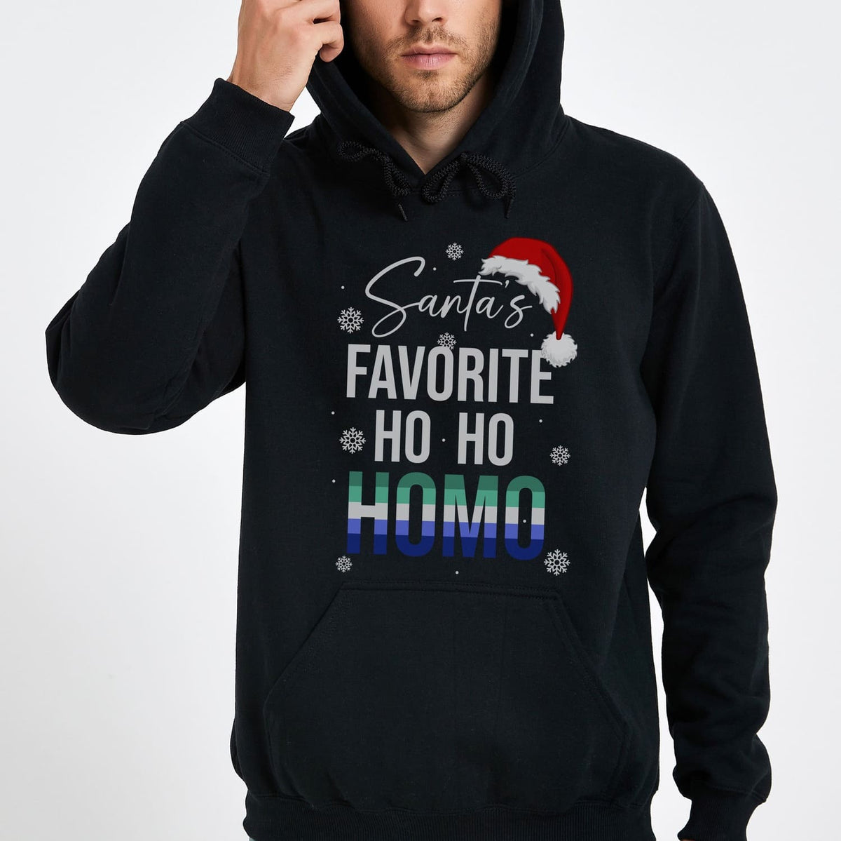 Black MLM gay christmas hoodie with 'Santa's Favorite Ho Ho Homo' text and rainbow design on a white background