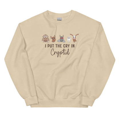 Beige sweatshirt with cryptid characters and text on a white background